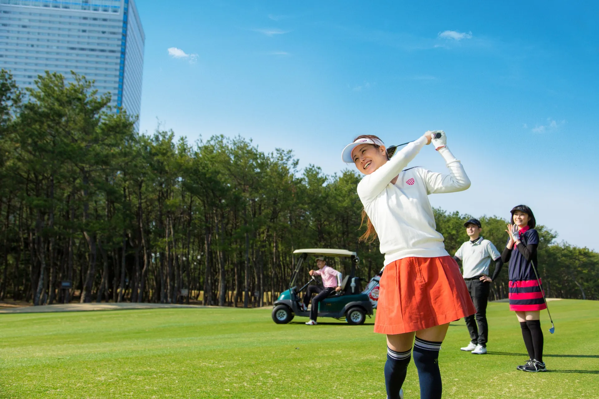 Golfers enjoying a round on a pine-lined course in Miyazaki, southern Japan
